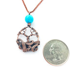 Mini swirling tree necklace with turquoise colored accent